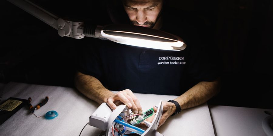 Corpoderm technician working on devices